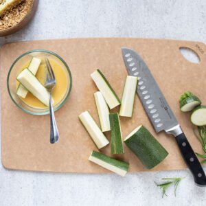 Sage 10.5" x 16" Cutting Board with knife and cut zucchini.