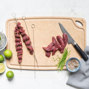 Sage 12" x 18" Carving Board With Non-Skid Feet with beef kabobs on it.