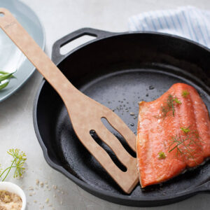 Sage Turner Tool in a skillet with salmon.