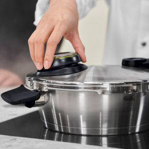 Hand adjusting pressure valve on Fissler Vitavit Premium 2.6qt Pressure Skillet